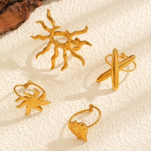 Detail view of a 4-piece set of vintage gold rings with bohemian textures and heart charms