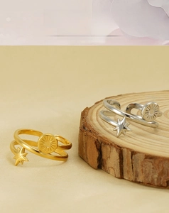 Detailed close-up of double-layer stainless steel star ring on wooden stand
