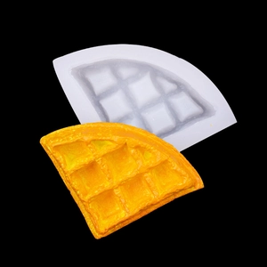 Macro shot of sector-shaped silicone waffle mold and a golden finished dessert cake product