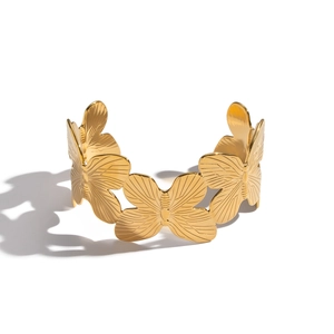 Exaggerated wide gold butterfly cuff bracelet in polished 18K plated stainless steel