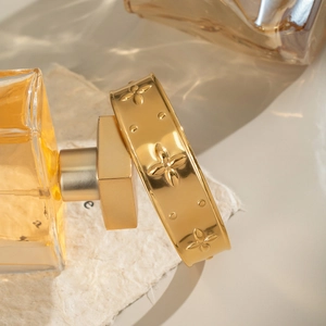 Detailed relief of clover patterns on a vintage gold plated stainless steel cuff bracelet