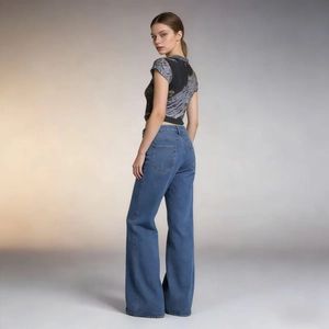 Side view of blue high-waisted flare jeans paired with a fitted short sleeve printed top