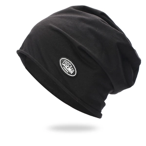 Unisex black slouchy beanie hat with fashion leather patch on a plain white background