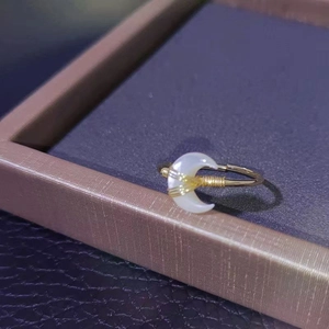 Elegant gold-tone open moon ring featuring white crescent inlay and wire wrap detailing