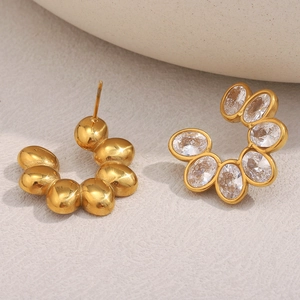 Detail of 18K gold-plated C-shaped earrings with sparkling cubic zirconia inlay