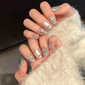 Green and silver press-on nails with cat eye finish and 3D rhinestones on wool texture