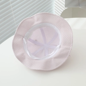 Detail of baby sun hat interior with adjustable drawstring and soft corduroy texture