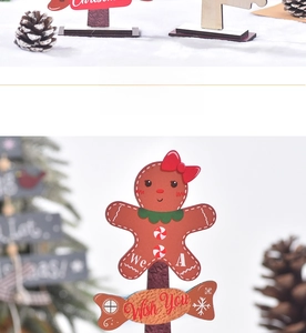 Detail of wooden gingerbread man and candy Christmas desktop ornaments with holiday text