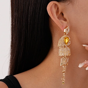 French vintage gold earrings with faux pearls and yellow teardrop gems on female model