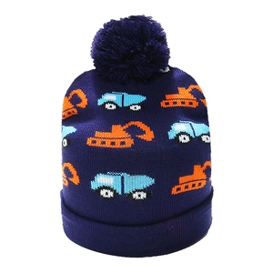 Detailed knit texture of navy blue kids beanie with orange excavator cartoon pattern