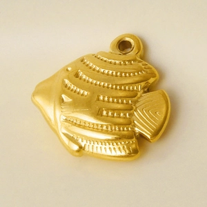Macro shot of 18k gold plated stainless steel fish pendant with embossed relief texture