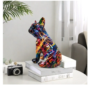 Detail of colorful graffiti resin French bulldog figurine on decorative books