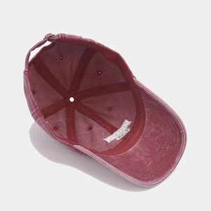Inside view of burgundy vintage washed cap showing reinforced seams and metal buckle