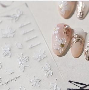 Detailed 5D white floral embossed nail stickers with elegant blossoms and artistic text