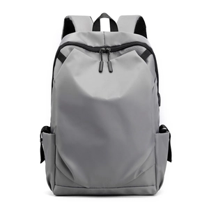 Large capacity grey nylon backpack with minimalist design and side pockets for outdoor travel