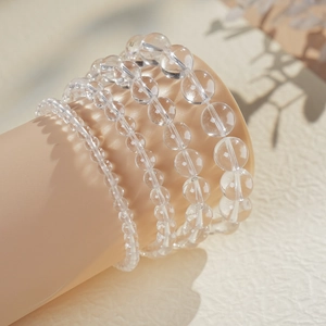 Close-up of transparent clear quartz beaded bracelets in four different bead sizes