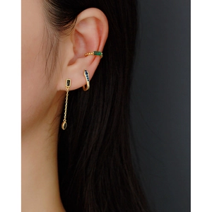 Gold earrings set featuring emerald rectangle stud, blue gem hoop, and black tassel drop