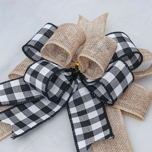 Handmade Christmas bow decoration with black and white plaid and natural burlap textures