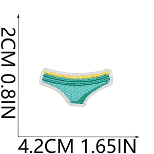 Detail of embroidered turquoise and yellow bikini patch showing 4.2cm x 2cm dimensions