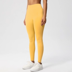 Macro detail of breathable bright yellow high waist seamless yoga leggings fabric texture
