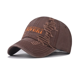 Detail of vintage washed brown cotton baseball cap with orange COVERI embroidery and distressed holes