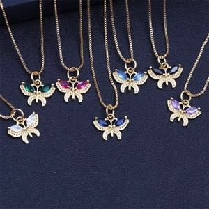Detail of colorful crystal butterfly pendants in various gem tones with gold chains