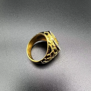Macro detail of gold plated hip hop ring with hollow textures and micro zircons