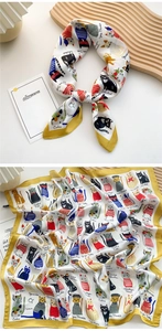 Detailed pattern of small square silk scarf featuring colorful cartoon cats and yellow borders