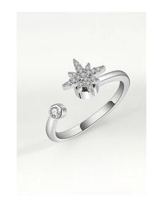 Detailed close-up of a silver rotating star ring with inlaid cubic zirconia and open band