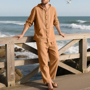 Detailed texture of ginger yellow linen long-sleeve hooded shirt and beach pants set