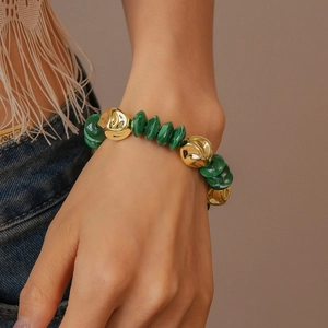 Detail of green malachite textured beads and gold textured balls on bohemian bracelet