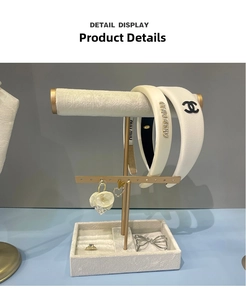 Detail view of T-bar jewelry display stand with white velvet lining and ring storage base