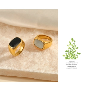 Polished gold-plated stainless steel rings with black and white inlay details