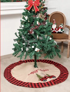 Detail of burlap Christmas tree skirt with red buffalo plaid border and vintage truck print