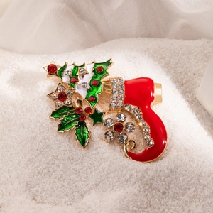 Detail of Christmas boot brooch with enamel holly leaves and sparkling rhinestones