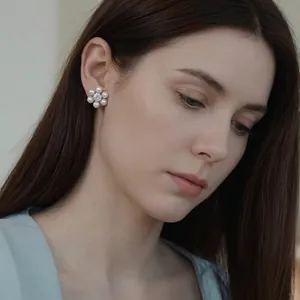 Elegant five-petal pearl flower stud earrings with zircon center shown on model