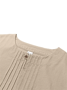 Detail of Henley neckline on beige cotton linen shirt showing size M label and button
