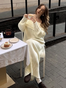 Close-up of off-white ribbed knit dress texture with off-shoulder design and long sleeves