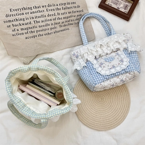 Detailed interior of quilted plaid tote bag showing ample space for cosmetics and books