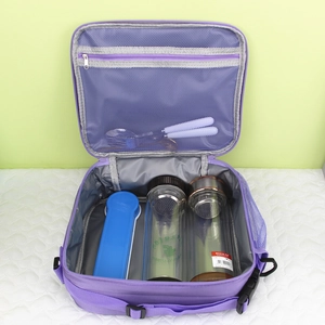 Spacious interior of purple insulated lunch bag with mesh pocket and storage for bottles