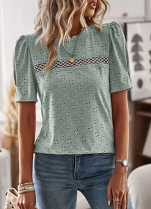 Close-up of light blue short sleeve top featuring intricate hollow lace and crochet detail