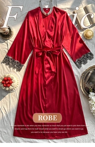 Detail of red satin robe sleeve featuring elegant black lace trim and silk texture