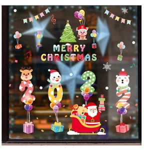 Close-up of Merry Christmas window stickers with Santa, reindeer, and snowman designs
