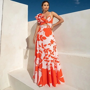 Close-up of orange floral swimsuit with ruffled shoulder detail and cutout design