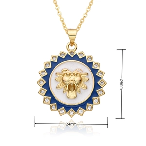 Macro detail of 24mm gold lion head pendant with blue enamel and zircon stones