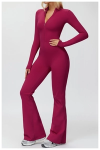 Detail view of pink long sleeve yoga jumpsuit with stand collar and flared legs