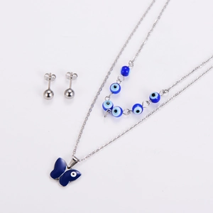 Close-up of double layer necklace and stud earrings set with blue butterfly and evil eye