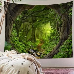 Detail of forest tapestry showing lush green trees and path hanging in a cozy bedroom