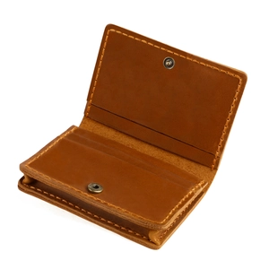 Macro detail of vintage brown crazy horse leather card holder with manual stitching
