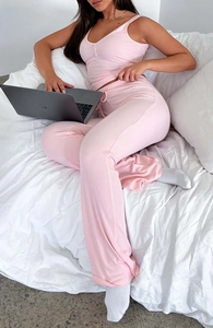 Cozy pink ribbed lounge set featuring a sleeveless button-up top and matching long pants